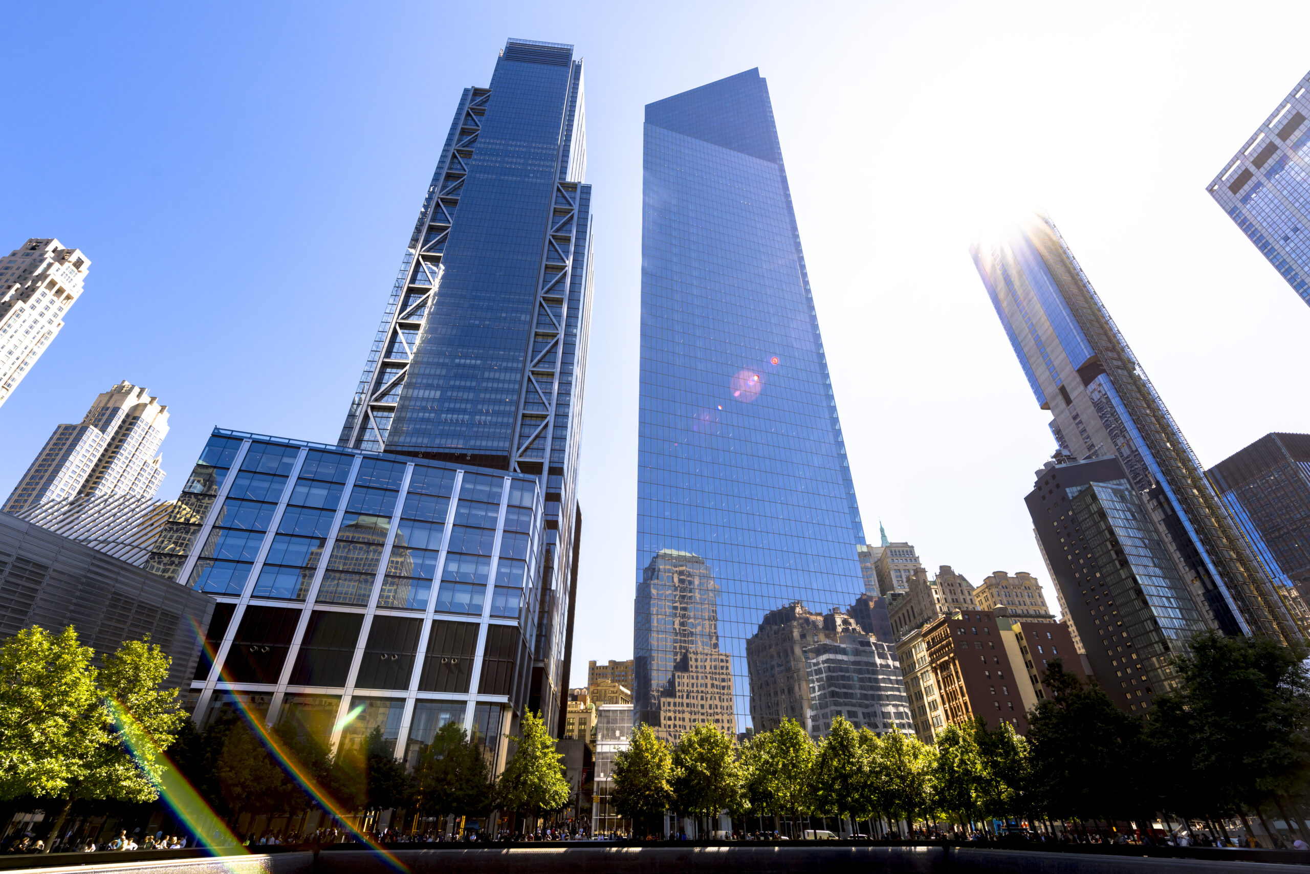 View of the National September 11 Memorial and Museum in New York, USA. Skyscrapers, greenery and people
